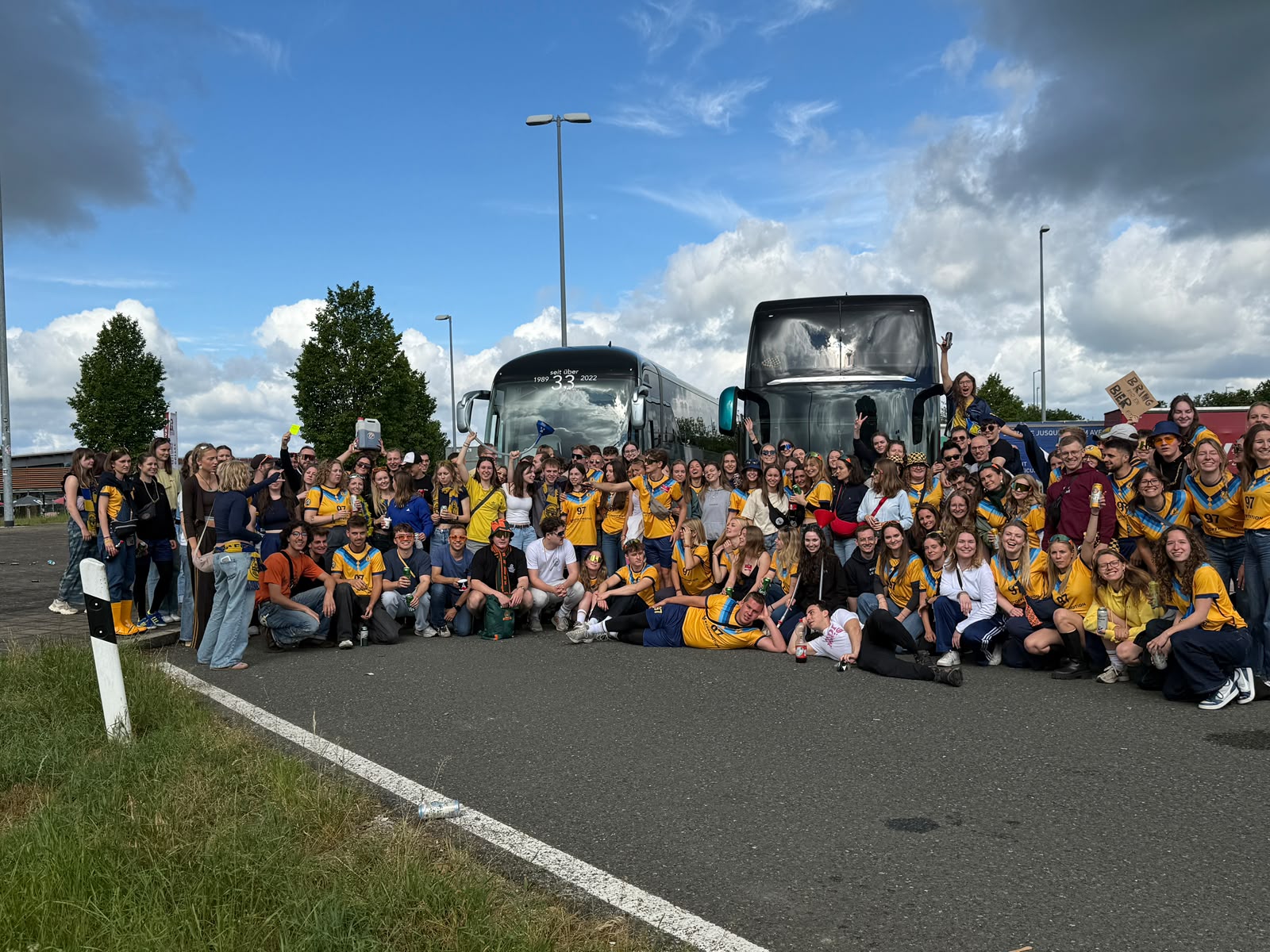 Medimeister travellers gathered together beside the coaches before departure