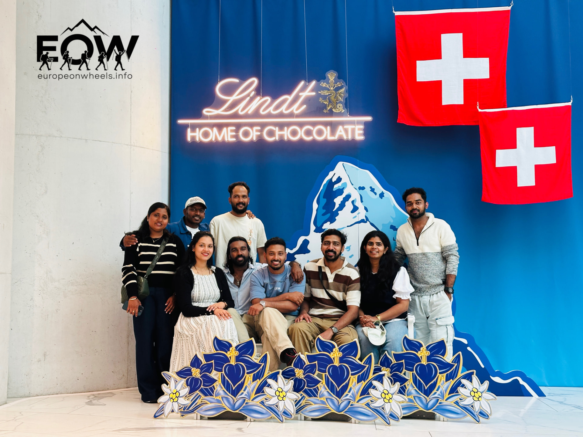 Tour group at the Lindt Home of Chocolate with Swiss flags near Zurich