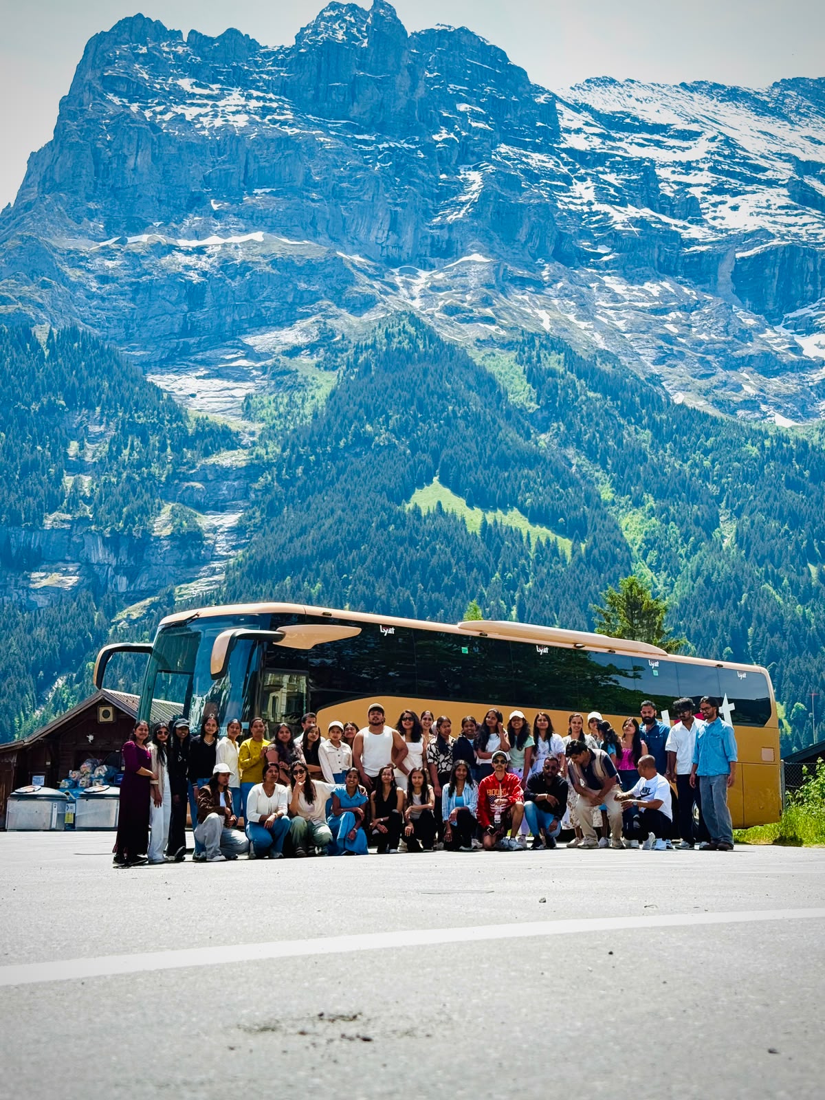 Full tour group in front of the gold coach beneath the Eiger, Grindelwald