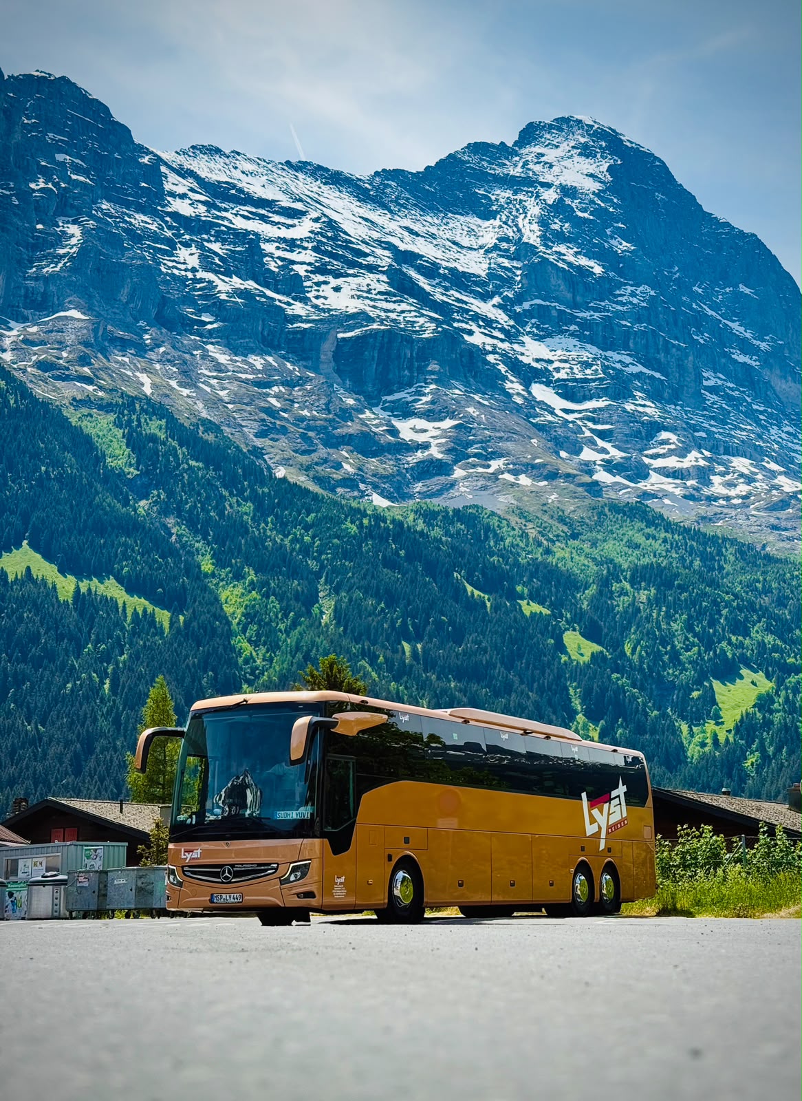Our gold coach parked below the snow-capped Eiger, Grindelwald