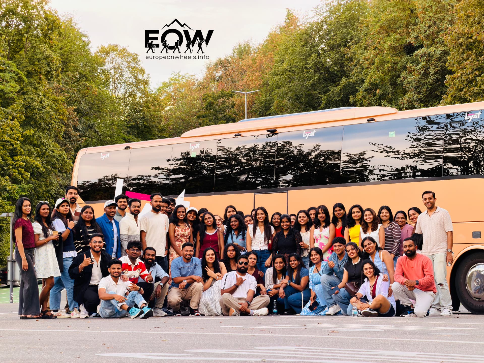 Europe on Wheels travellers gathered beside the gold coach in the Swiss countryside