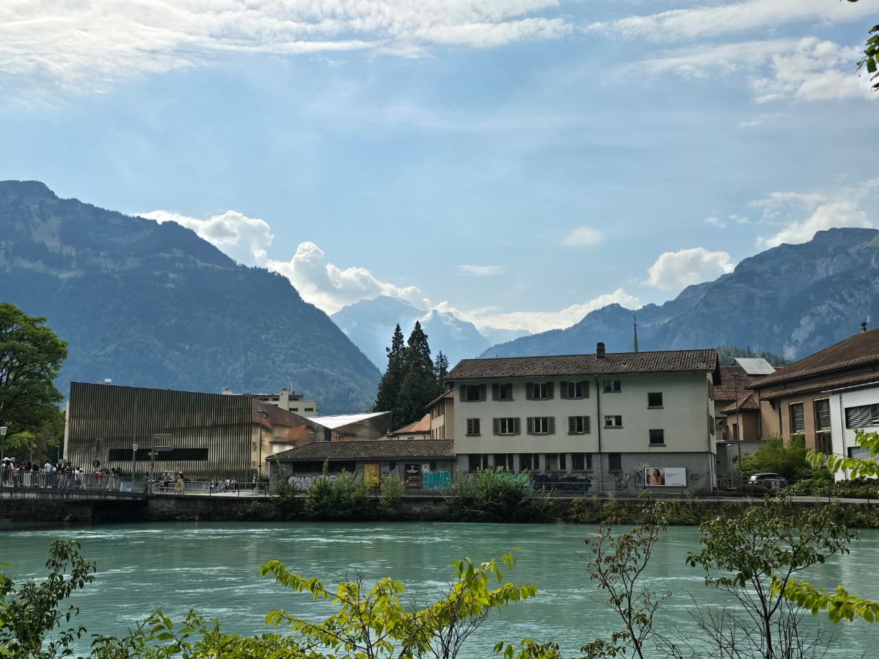 Interlaken riverfront buildings with the Swiss mountains behind